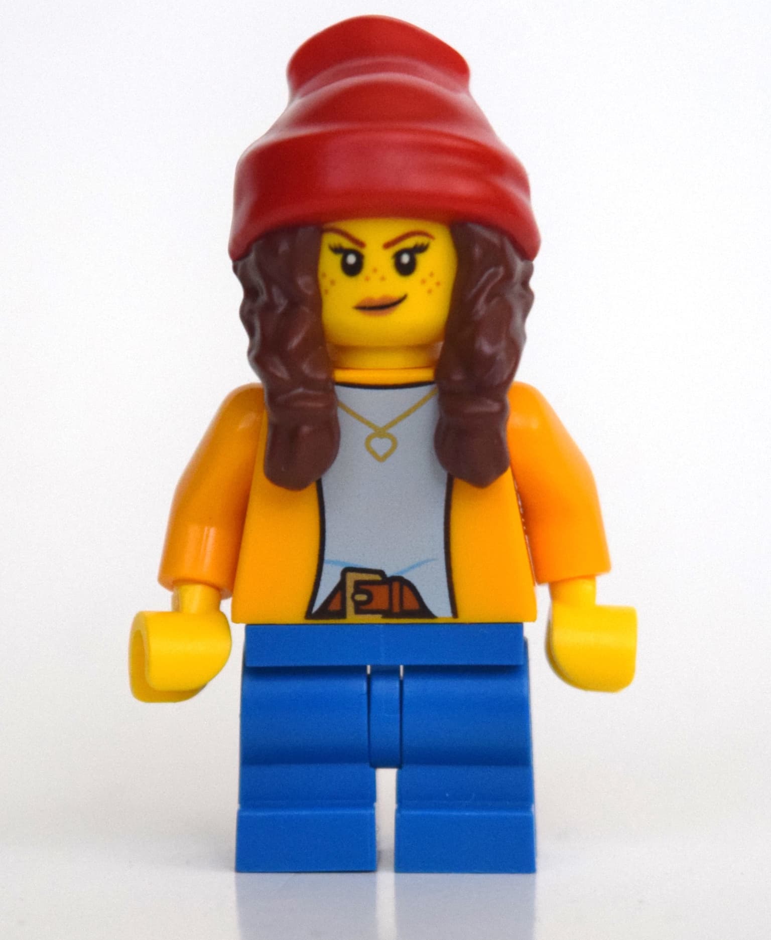 Girl, Bright Light Orange Shirt, Blue Medium Legs, Red Beanie with Braids